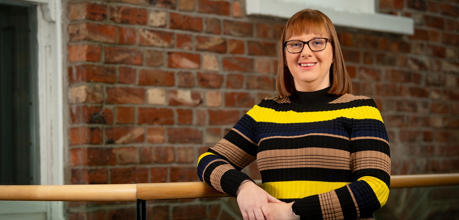 Dr Bronagh Byrne standing in the upper landing above the School of SSESW foyer