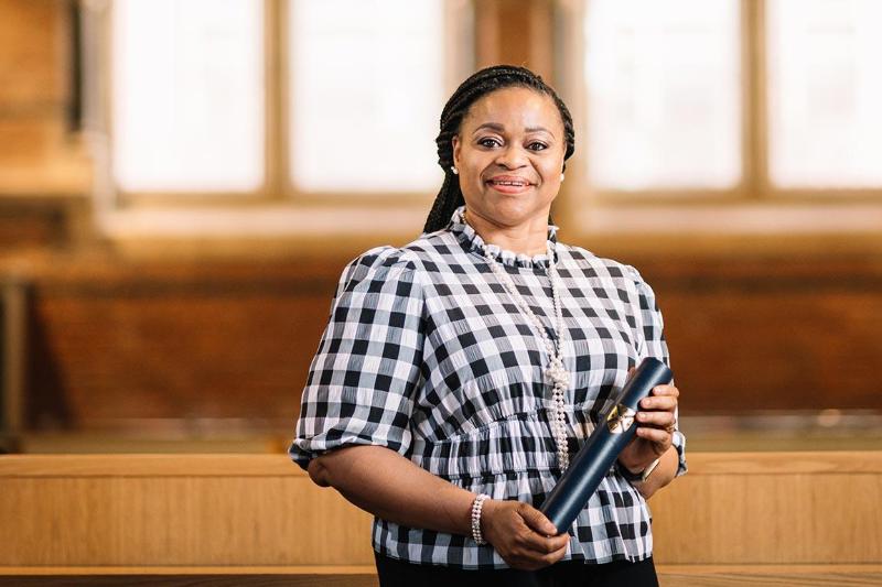 Nkem holding a scroll