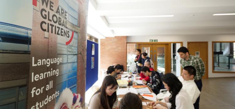 Student and staff at the Language Centre stall table, Summer Social and Wellbeing event, Peter Froggatt Centre