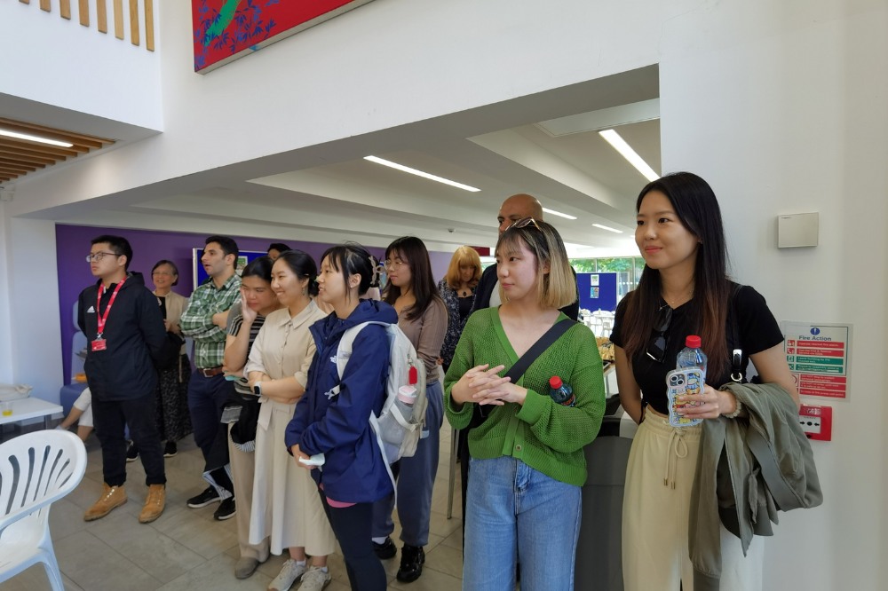 Students and staff watching a Tai-chi / Taiji demonstration in the Peter Froggatt Centre