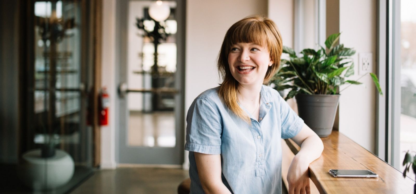 A woman sitting at a desk smiling