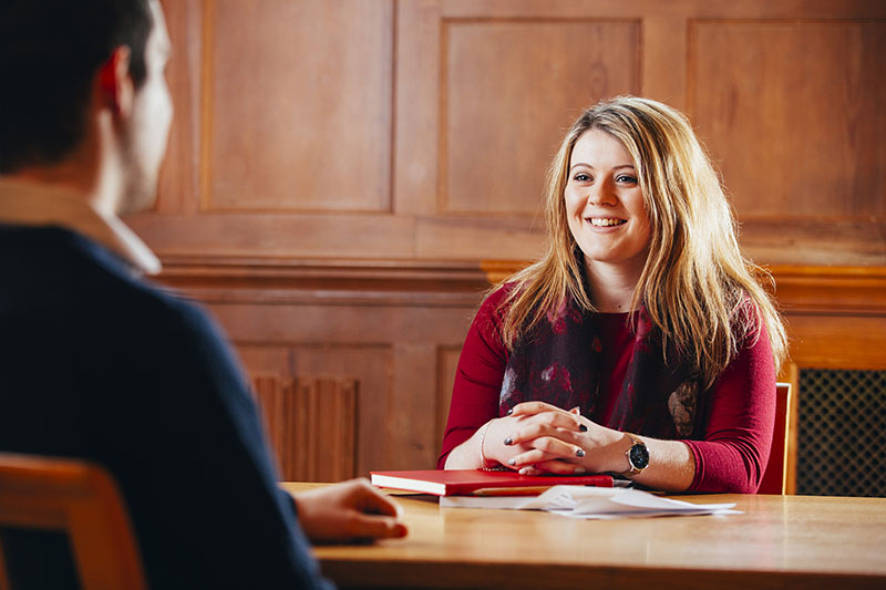 smiling female student at a desk