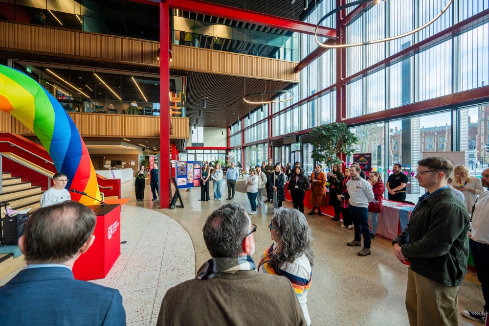 attendees listening to a guest speaker at the LGBTQueen's Celebration Showcase taking place in One Elmwood, Queen's University Belfast