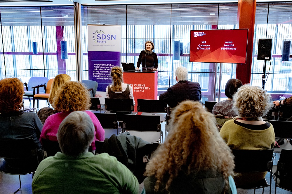 Artist Ingrid Hess speaking to attendees at the launch of the Reach '24 arts and sustainability festival at Queen's